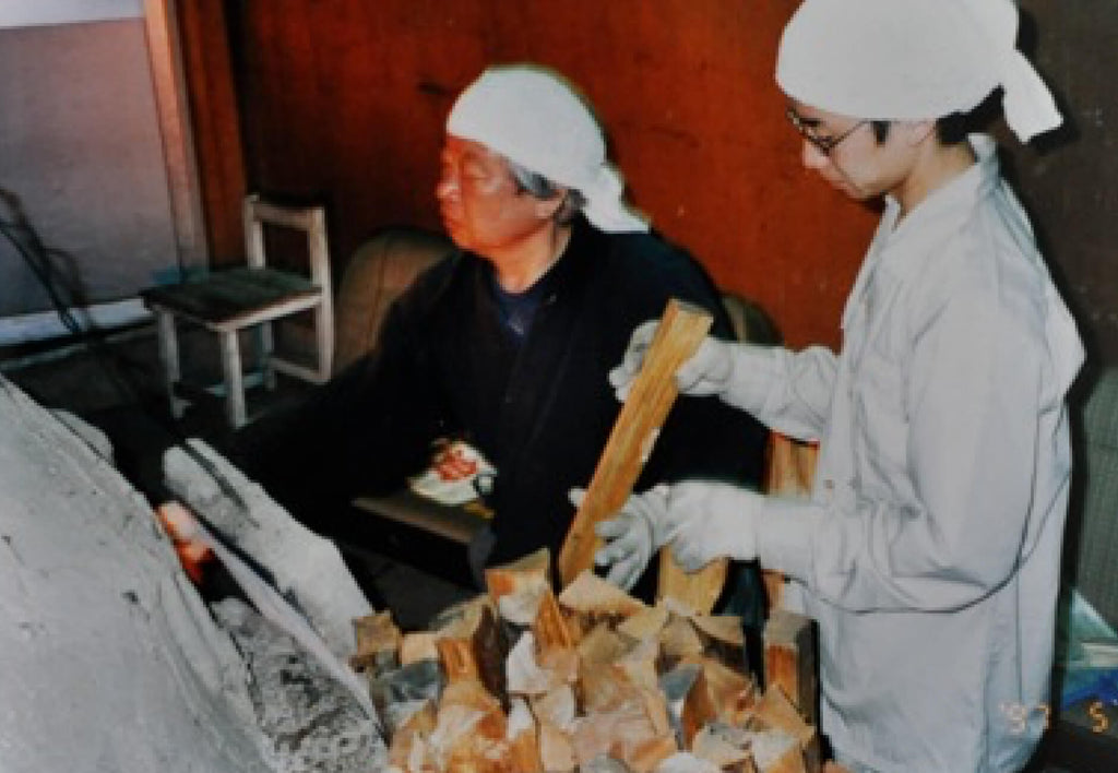 20-YEAR OLD MORIMOTO HELPING HIS FATHER AT A “NOBORI-GAMA” (WOODFIRED CLIMBING KILN).